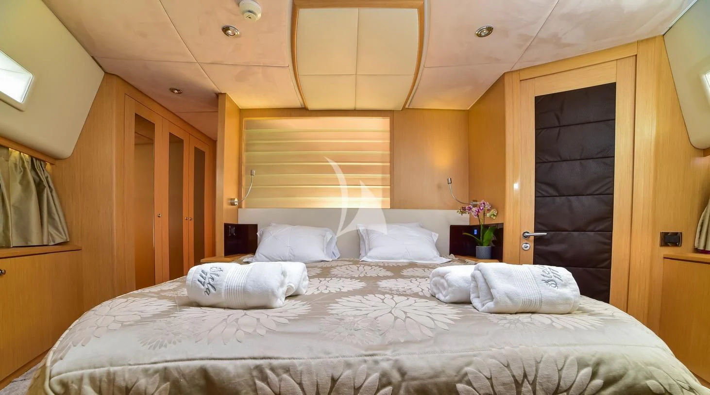 a bed with white sheets aboard STELA 117 Yacht for Sale