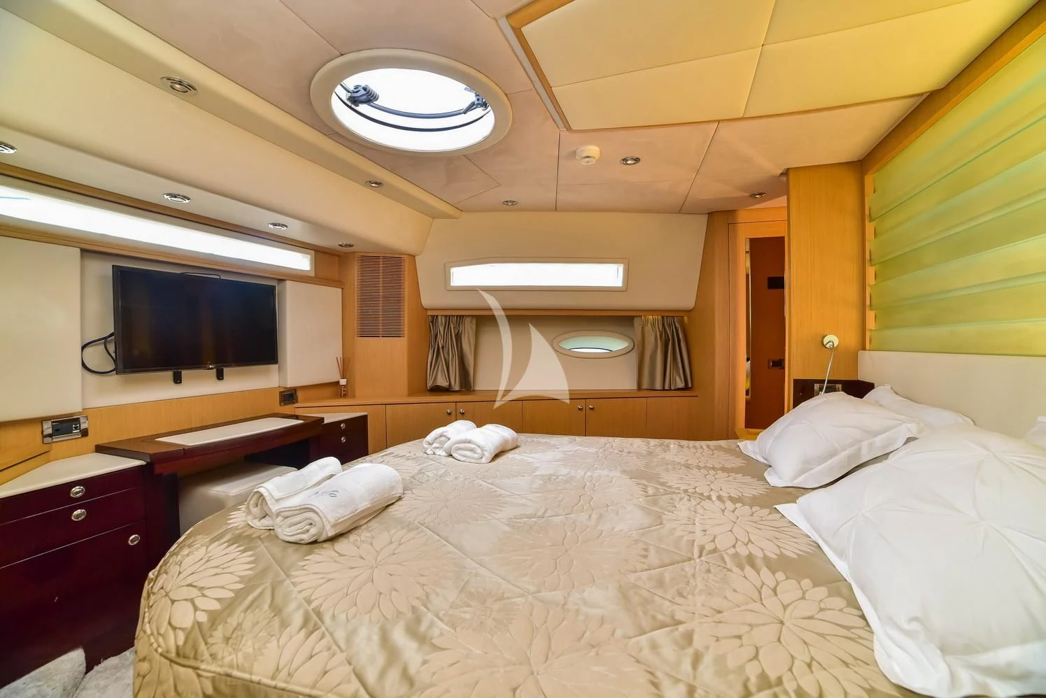 a room with a bed and a television aboard STELA 117 Yacht for Sale