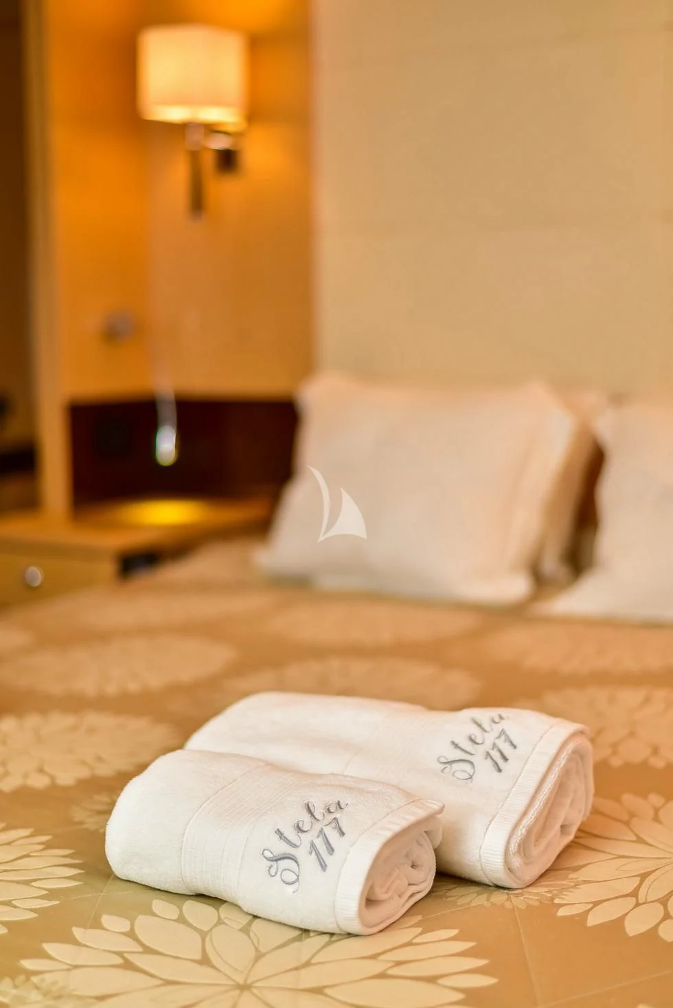 a pair of white slippers on a bed aboard STELA 117 Yacht for Sale