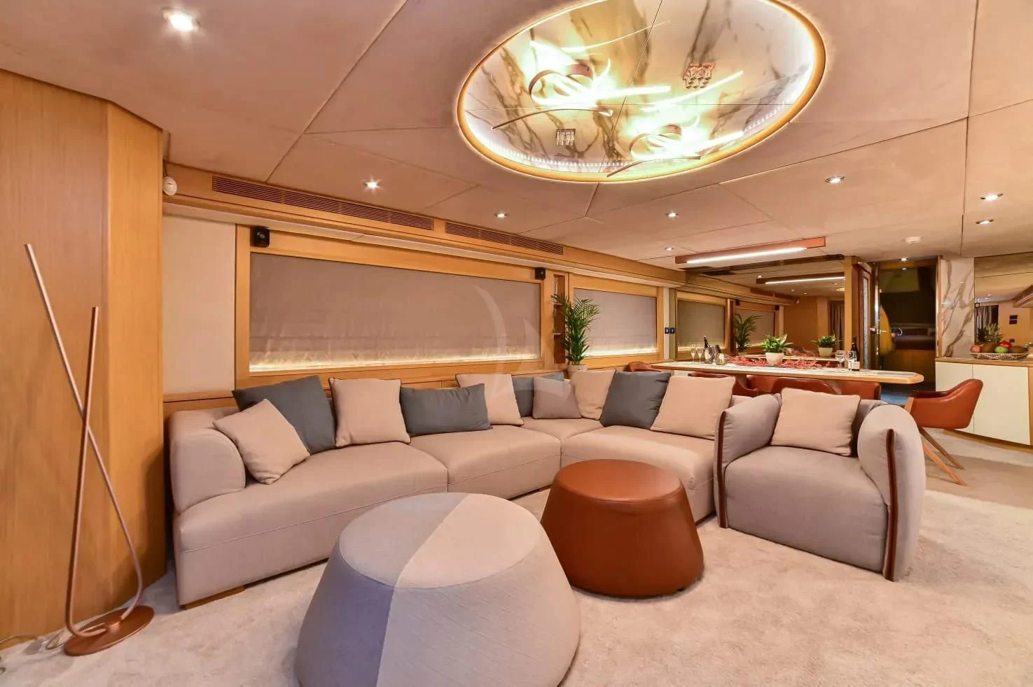 a large living room with a large chandelier aboard STELA 117 Yacht for Sale
