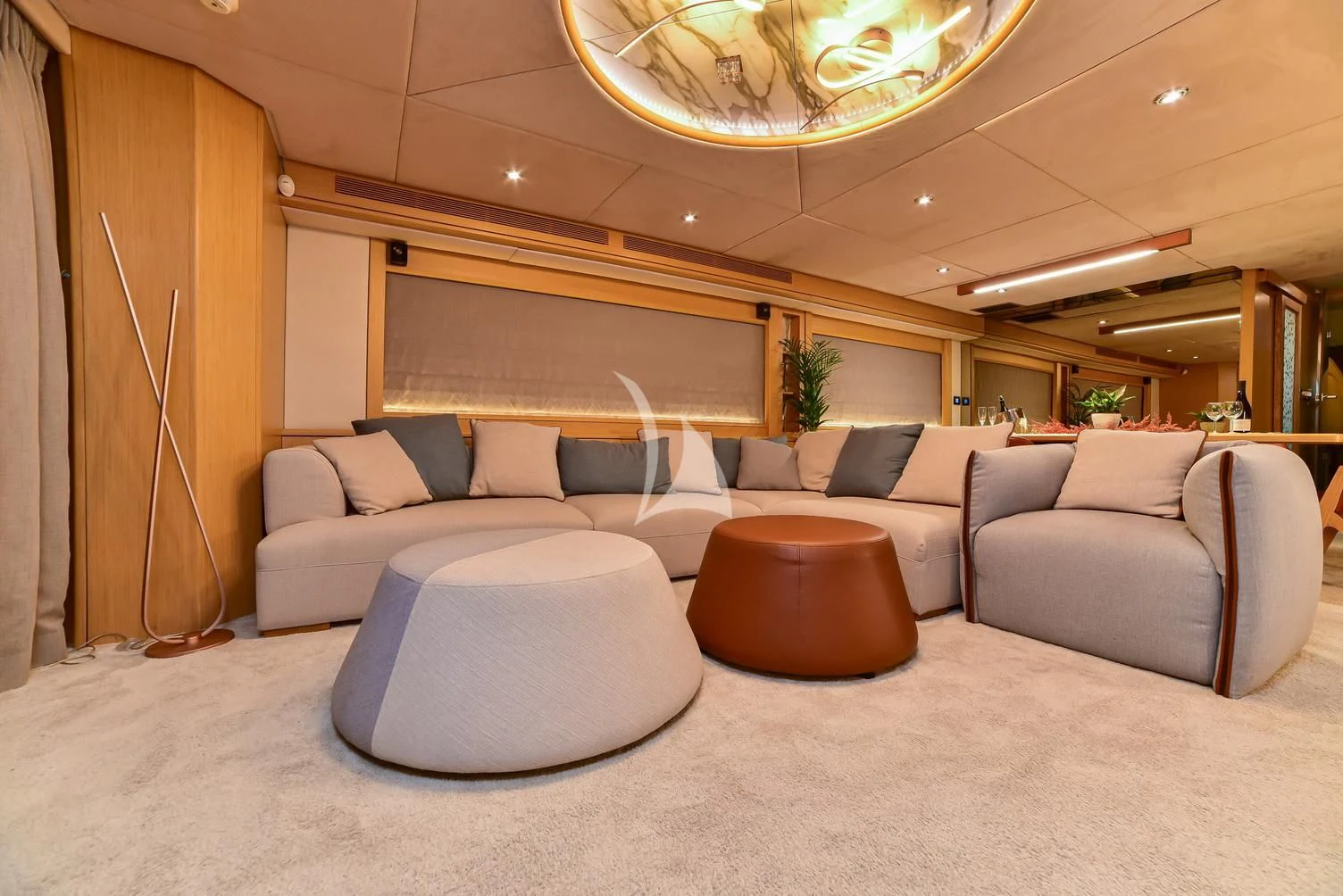 a large living room with a chandelier aboard STELA 117 Yacht for Sale