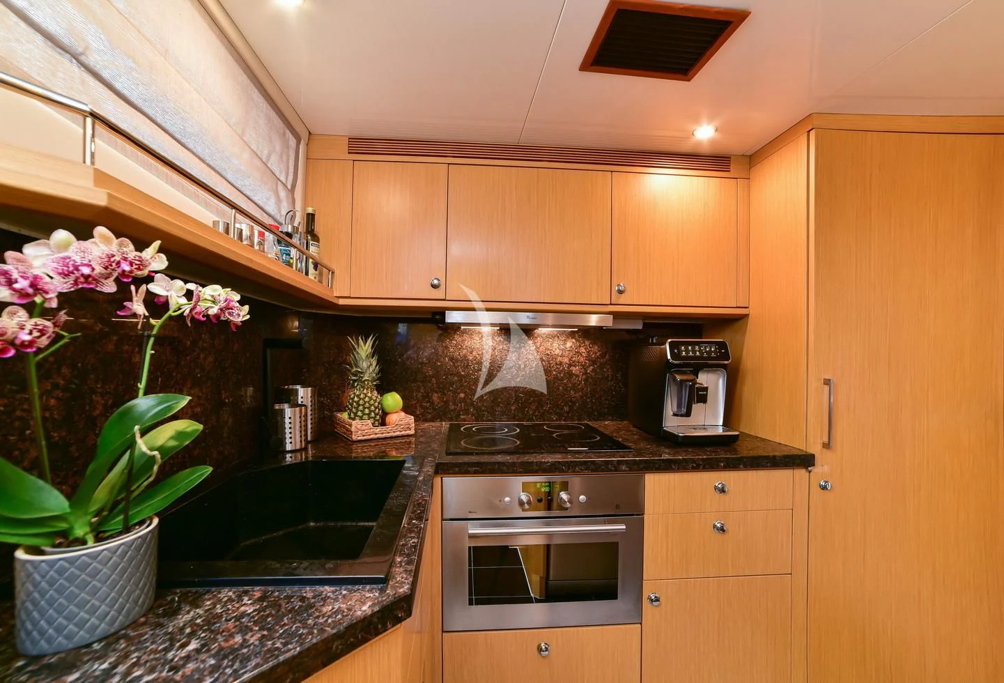 a kitchen with a rock wall aboard STELA 117 Yacht for Sale