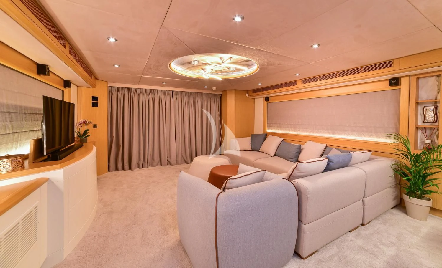 a living room with a couch and a television aboard STELA 117 Yacht for Sale