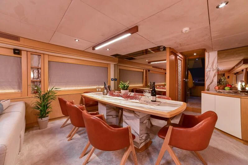 a kitchen with a table and chairs aboard STELA 117 Yacht for Sale