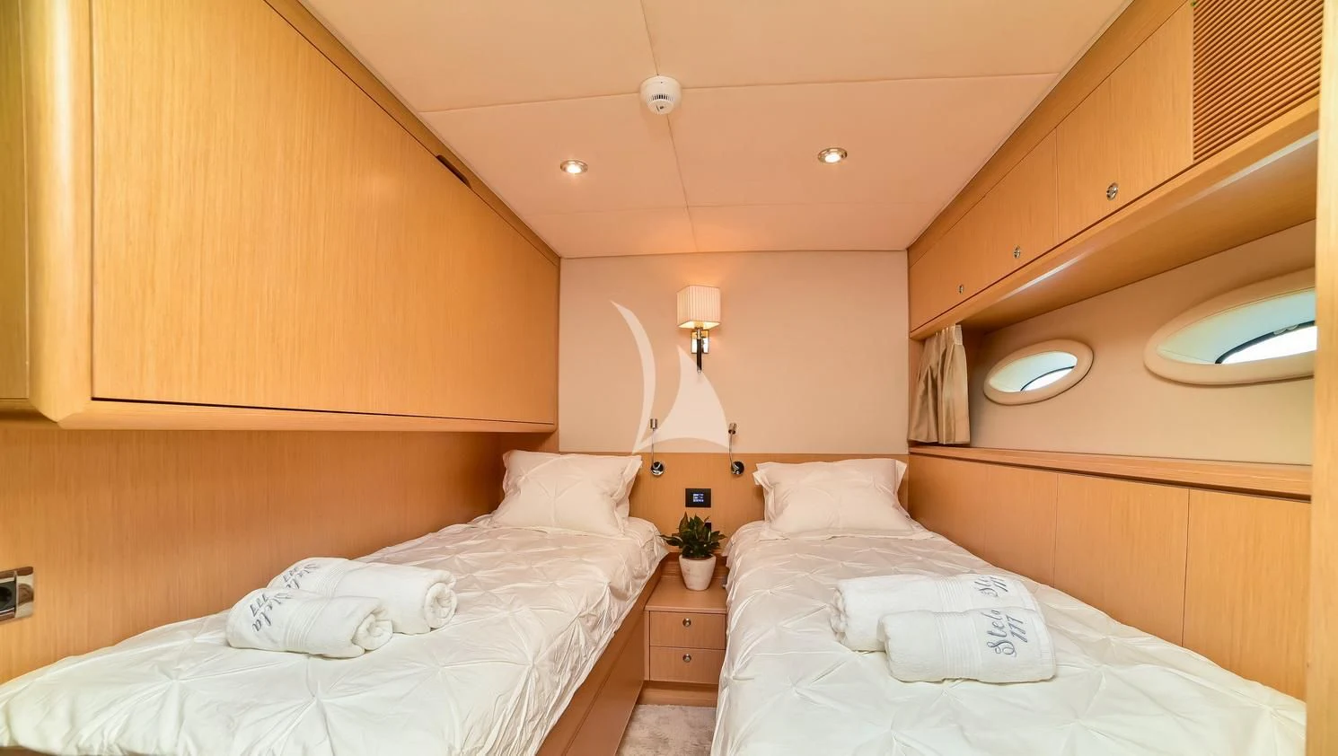 a room with two beds aboard STELA 117 Yacht for Sale
