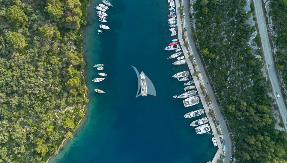 a river with a boat and trees aboard STELA 117 Yacht for Sale