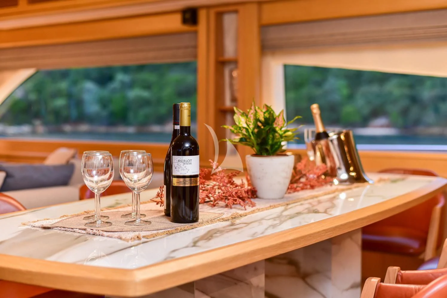 a table with wine glasses and bottles aboard STELA 117 Yacht for Sale