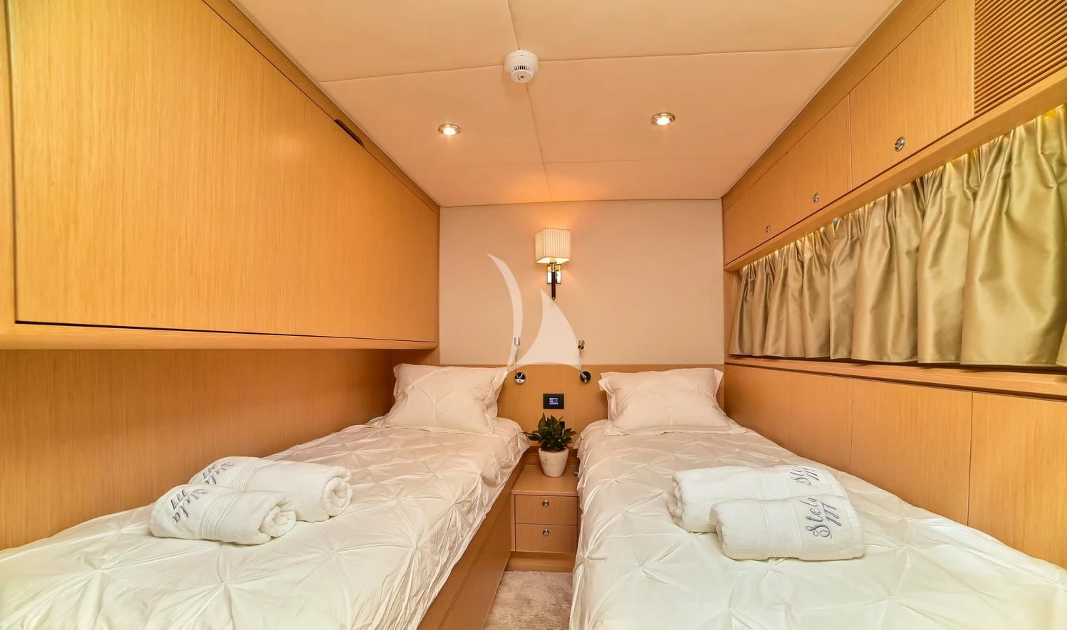 a room with a bed and a lamp aboard STELA 117 Yacht for Sale