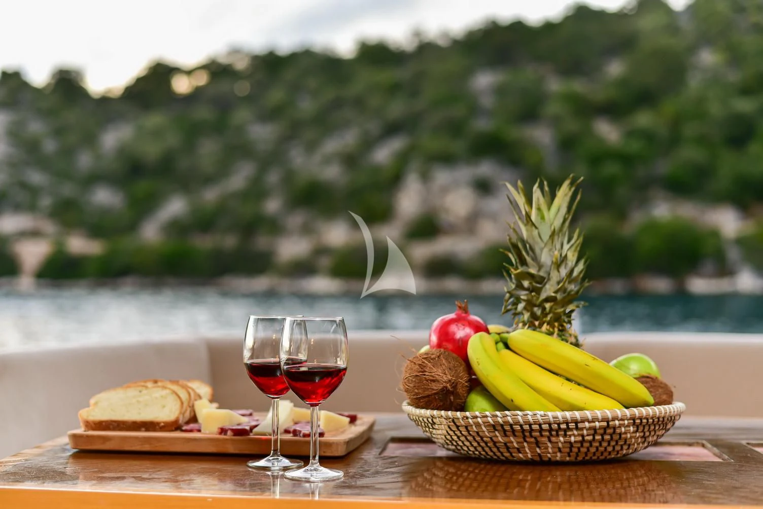 a table with food and wine aboard STELA 117 Yacht for Sale