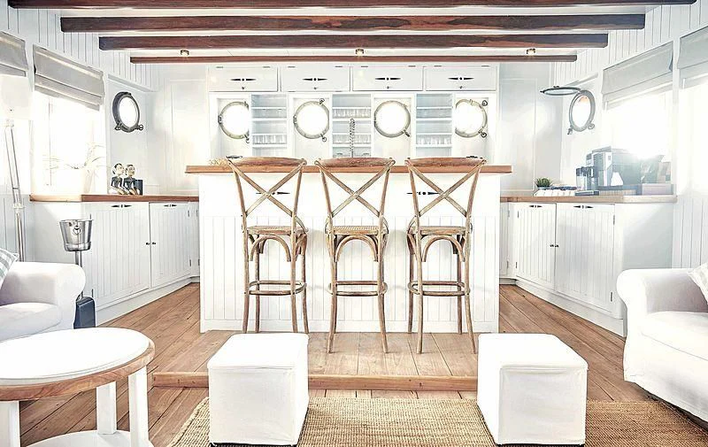 a kitchen with a table chairs and a bench aboard MISCHIEF Yacht for Sale