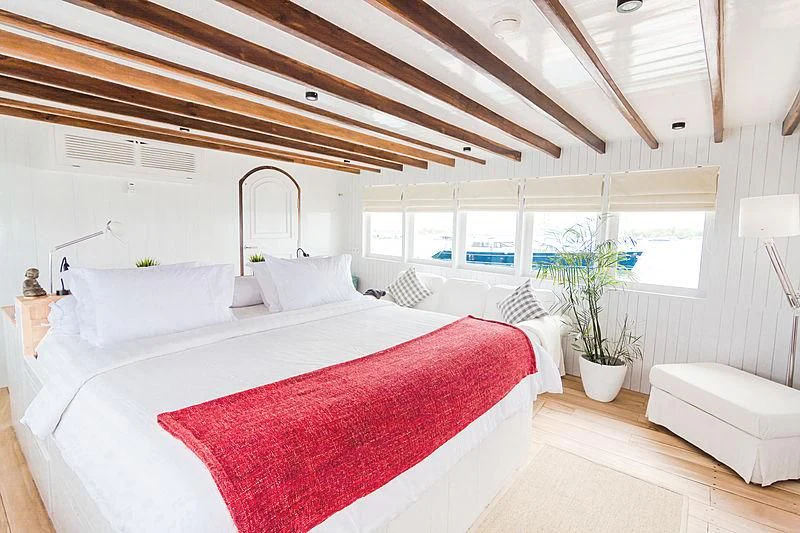 a room with a bed and a window aboard MISCHIEF Yacht for Sale