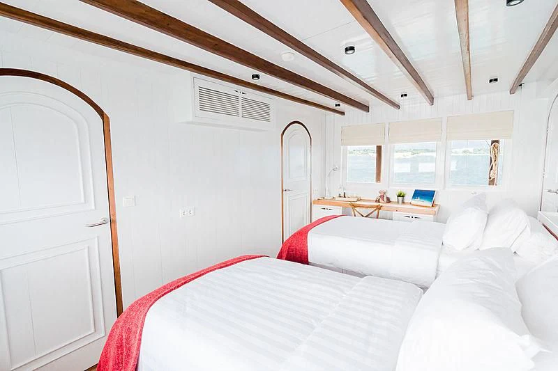 a room with white furniture aboard MISCHIEF Yacht for Sale