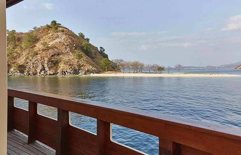 a body of water with a rock cliff and trees on the side aboard MISCHIEF Yacht for Sale