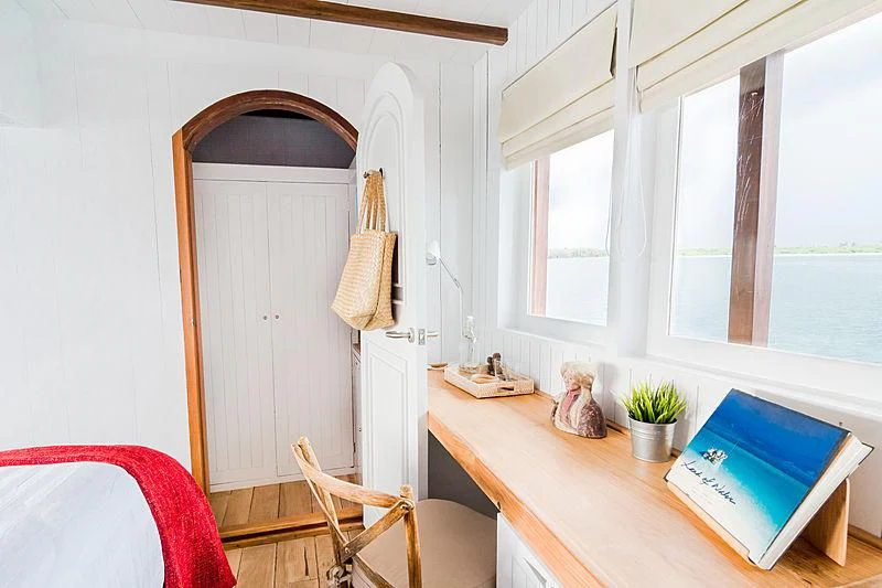 a room with a desk and a book on the table aboard MISCHIEF Yacht for Sale