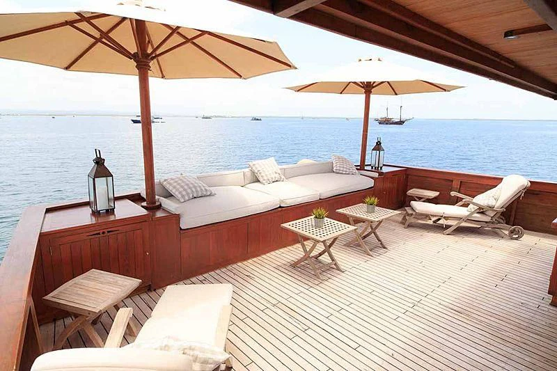 a lounge area with a large umbrella aboard MISCHIEF Yacht for Sale
