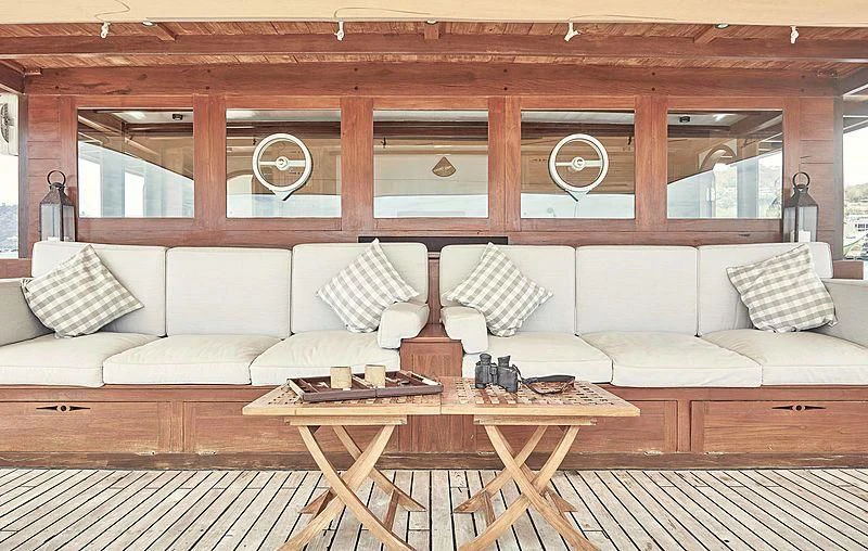 a room with a couch and a coffee table aboard MISCHIEF Yacht for Sale