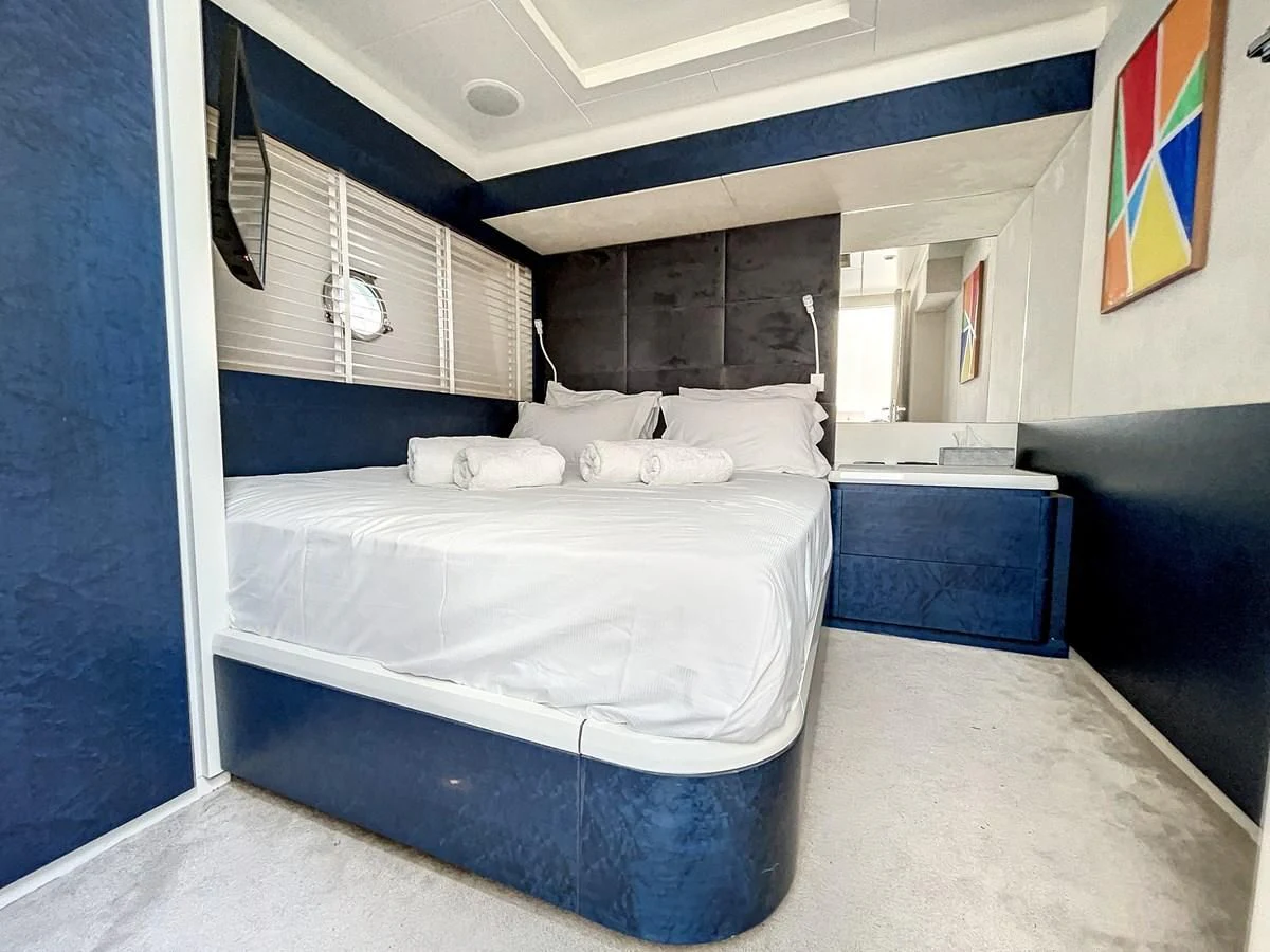 a room with a bed and a desk aboard LA FENICE Yacht for Charter