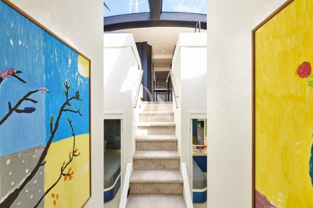 a stairway with a blue door aboard LA FENICE Yacht for Charter