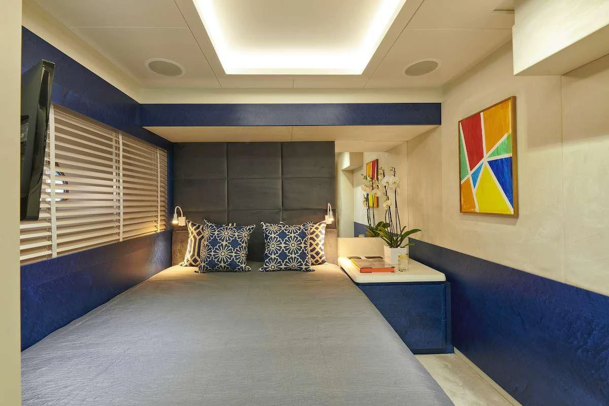 a bedroom with a bed and a desk aboard LA FENICE Yacht for Charter