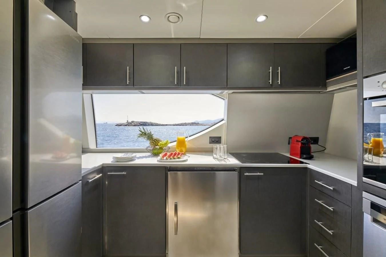 a kitchen with black cabinets aboard LA FENICE Yacht for Charter