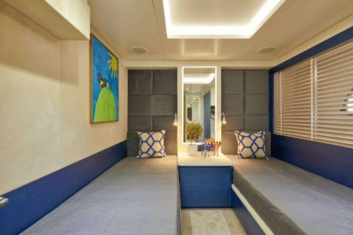 a room with a blue bed and a blue pillow aboard LA FENICE Yacht for Charter