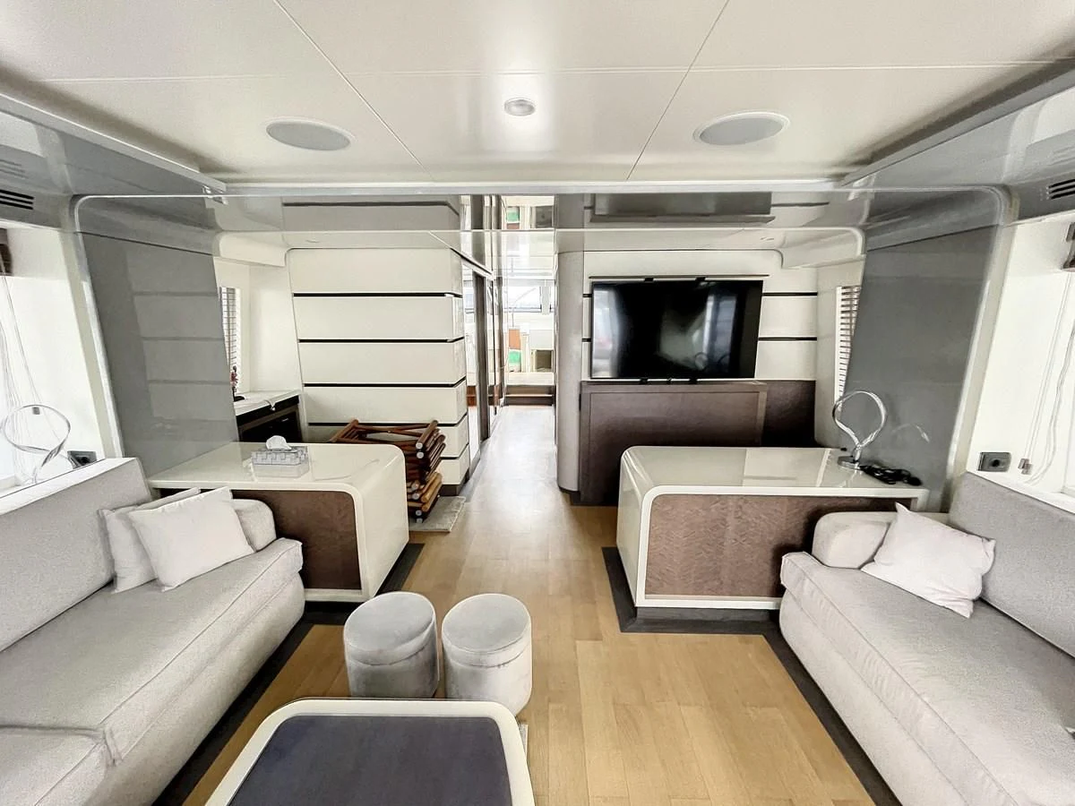 a living room with a large tv aboard LA FENICE Yacht for Charter