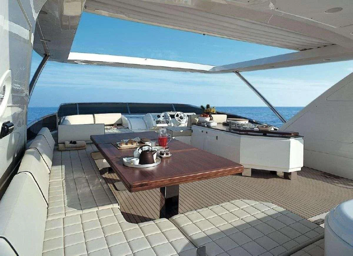 a table with a glass of wine on it aboard LA FENICE Yacht for Charter