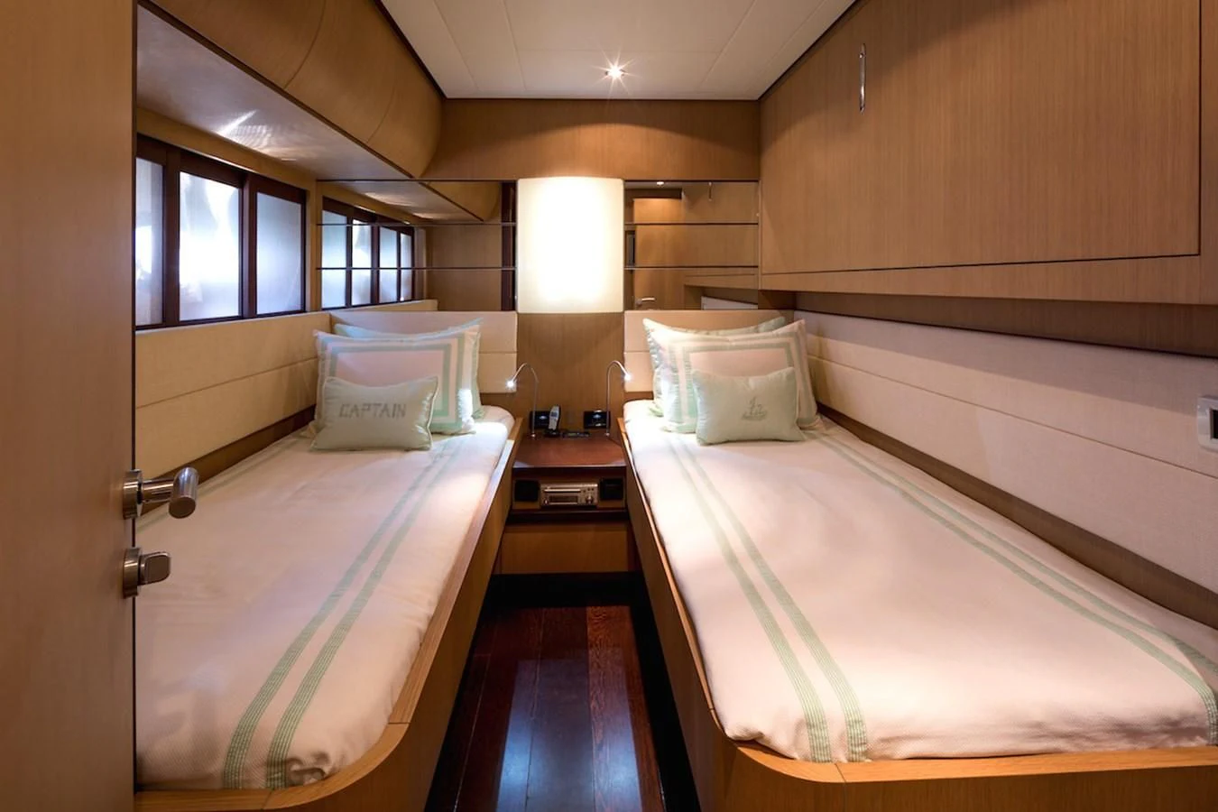 a couple of beds in a room aboard ONE Yacht for Charter