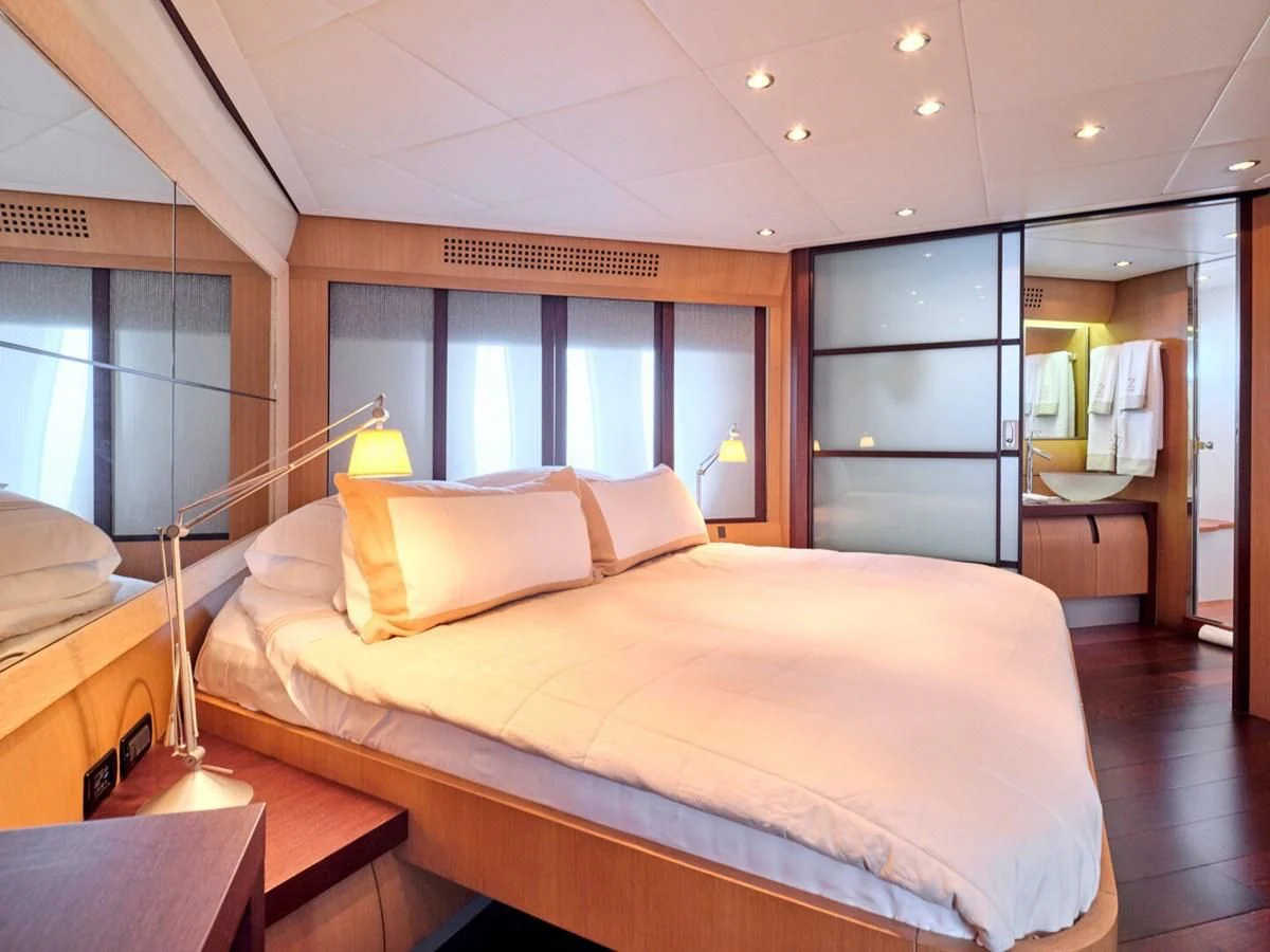 a bed in a room aboard ONE Yacht for Charter