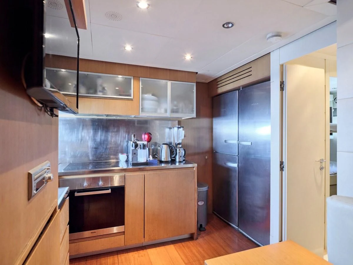 a kitchen with a steel stove aboard ONE Yacht for Charter
