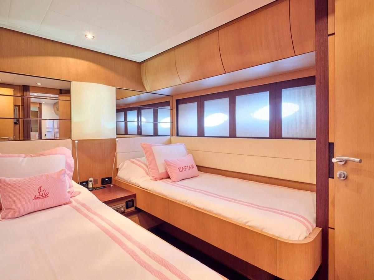 a couple of beds in a hotel room aboard ONE Yacht for Charter