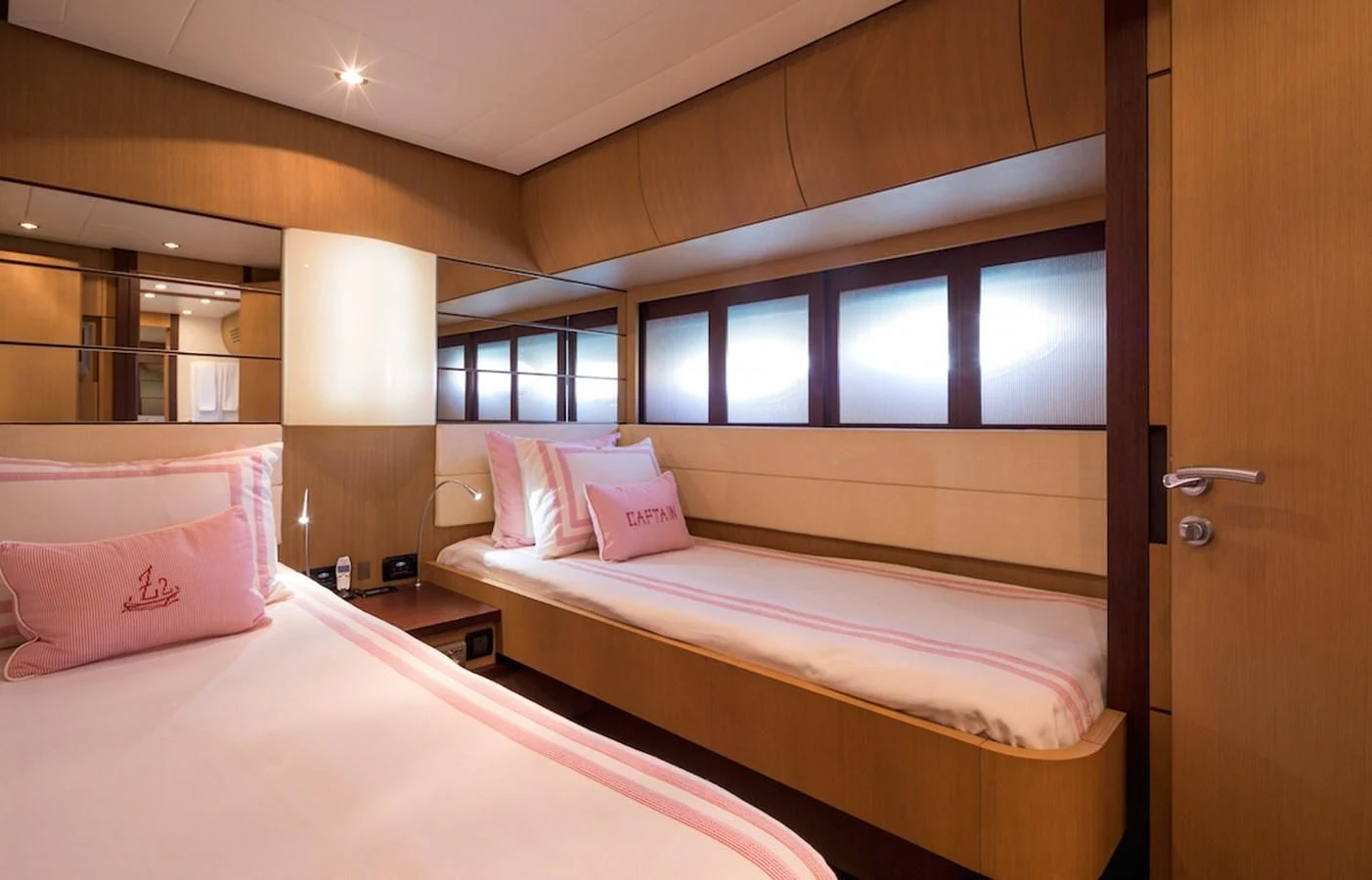 a couple of beds in a room aboard ONE Yacht for Charter