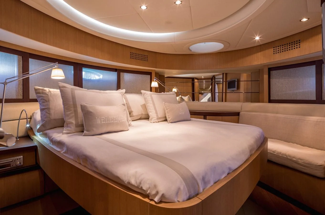 a bed with white sheets aboard ONE Yacht for Charter