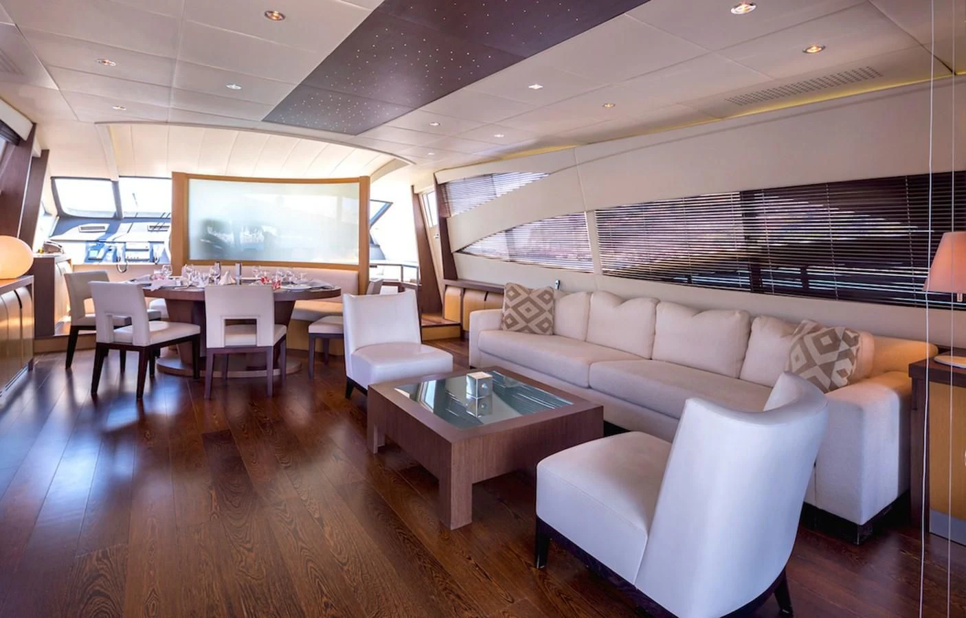 a living room with a large screen aboard ONE Yacht for Charter
