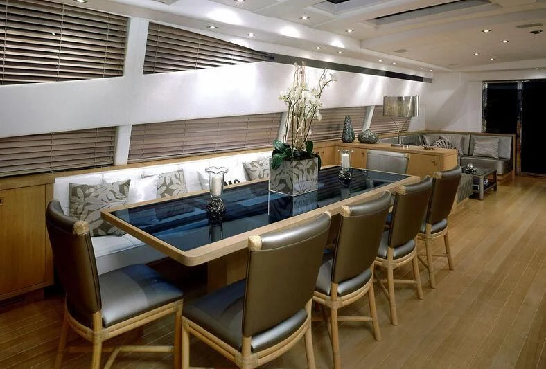 a room with a pool table and chairs aboard MARIA CARLA Yacht for Sale