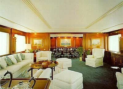 a living room with a large table and chairs aboard TRANQUILLITY Yacht for Sale