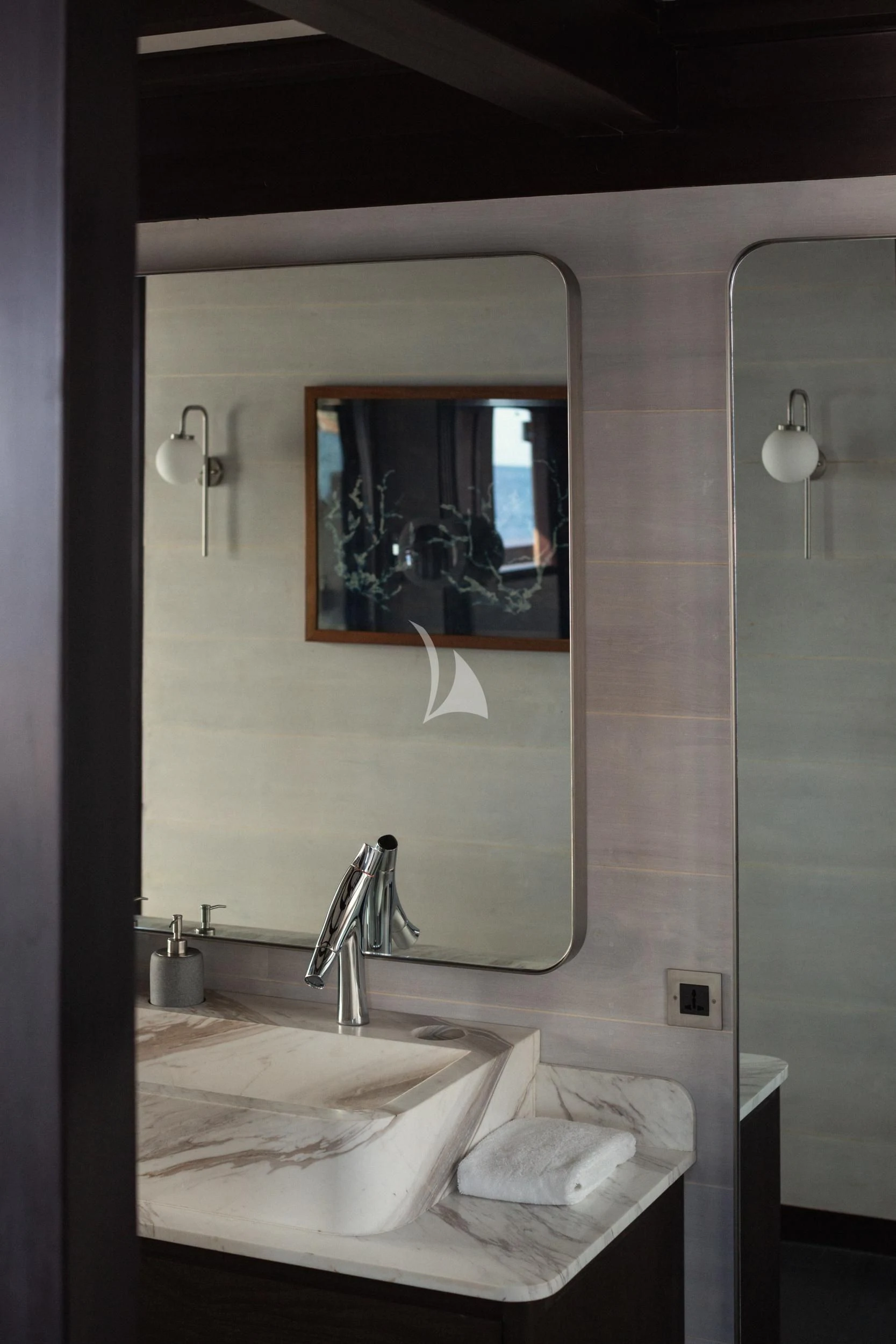 a bathroom with a large mirror aboard VELA Yacht for Charter