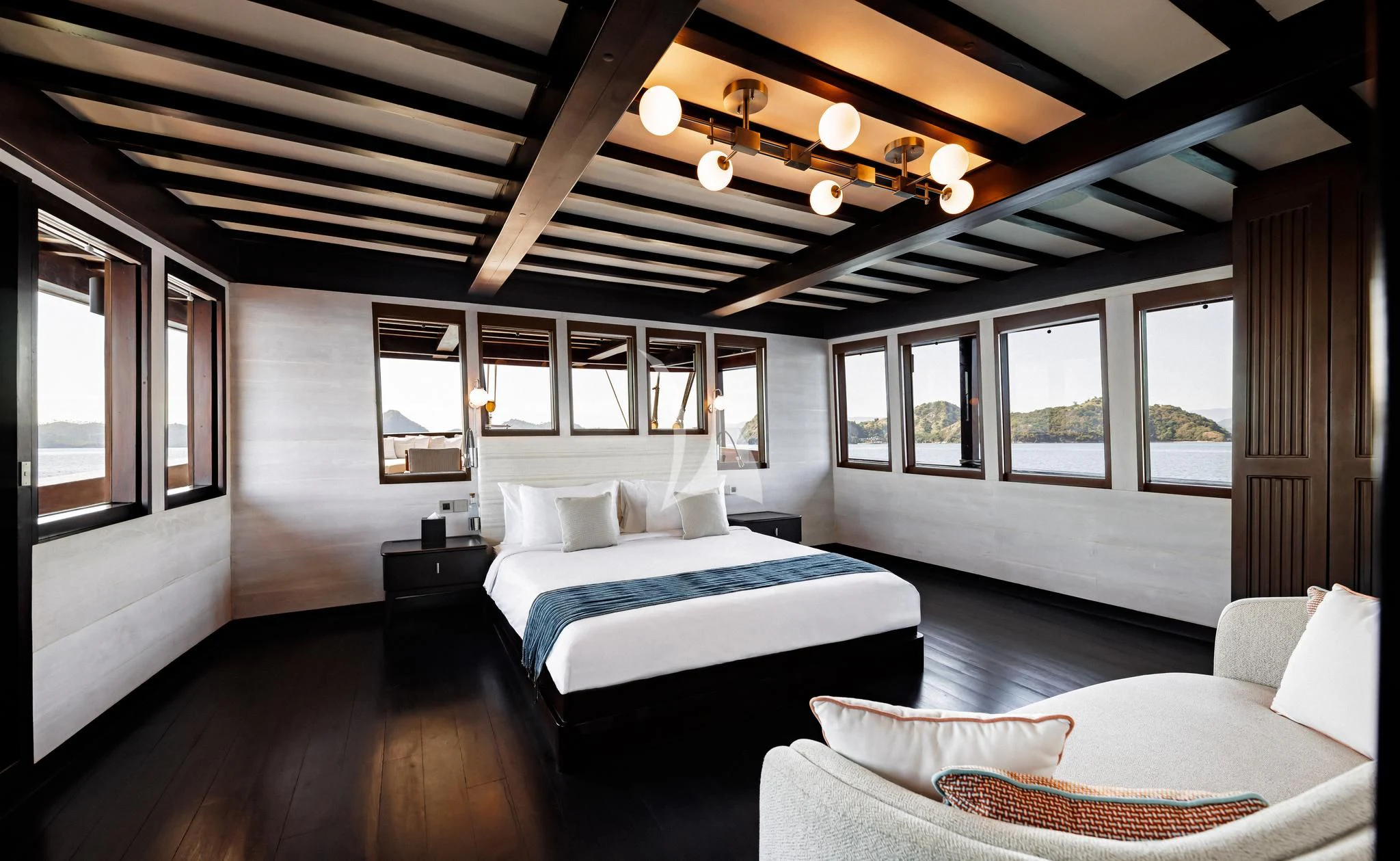 a room with a bed and a window aboard VELA Yacht for Charter