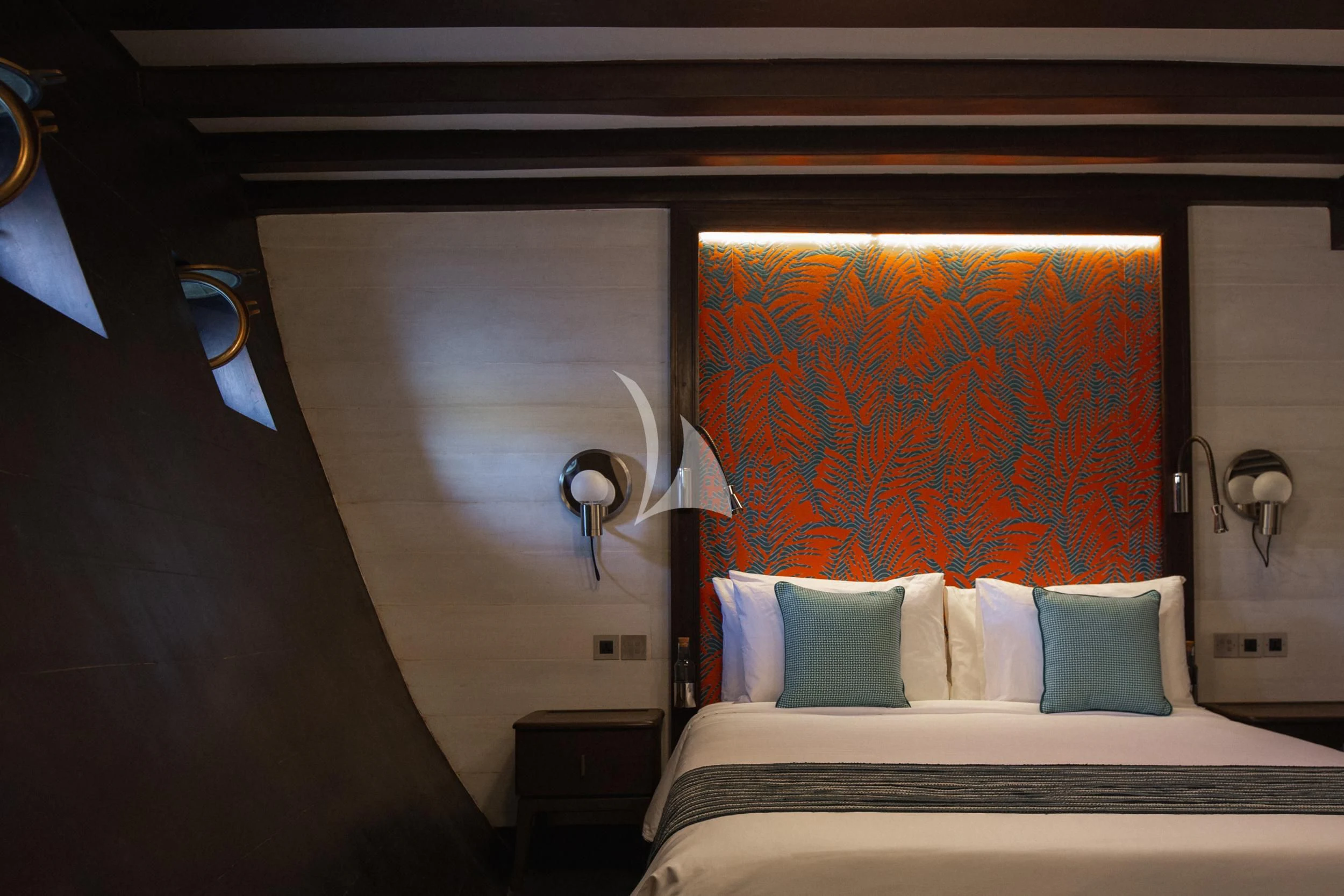 a bedroom with a painting on the wall aboard VELA Yacht for Charter