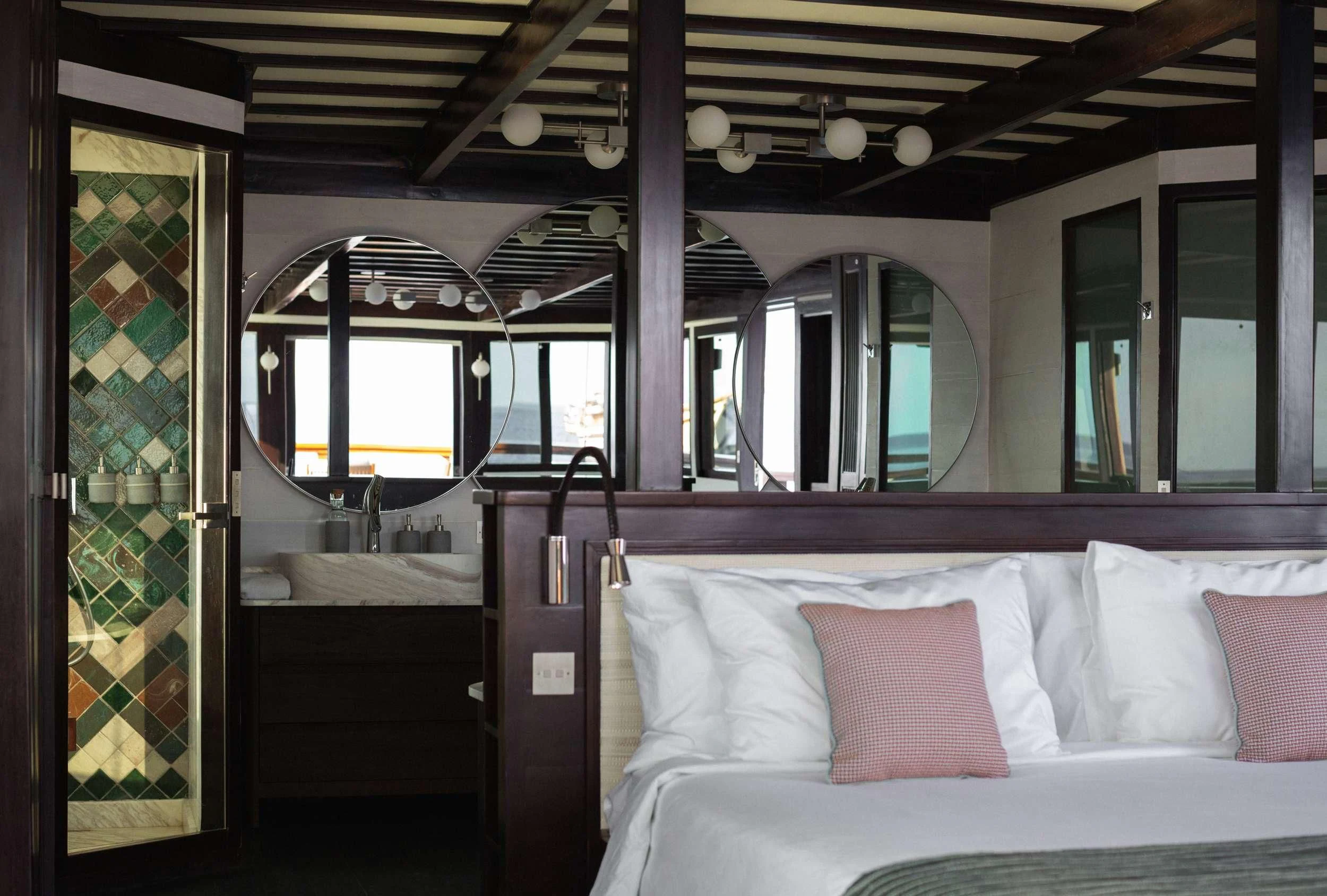 a room with a bed and a window aboard VELA Yacht for Charter