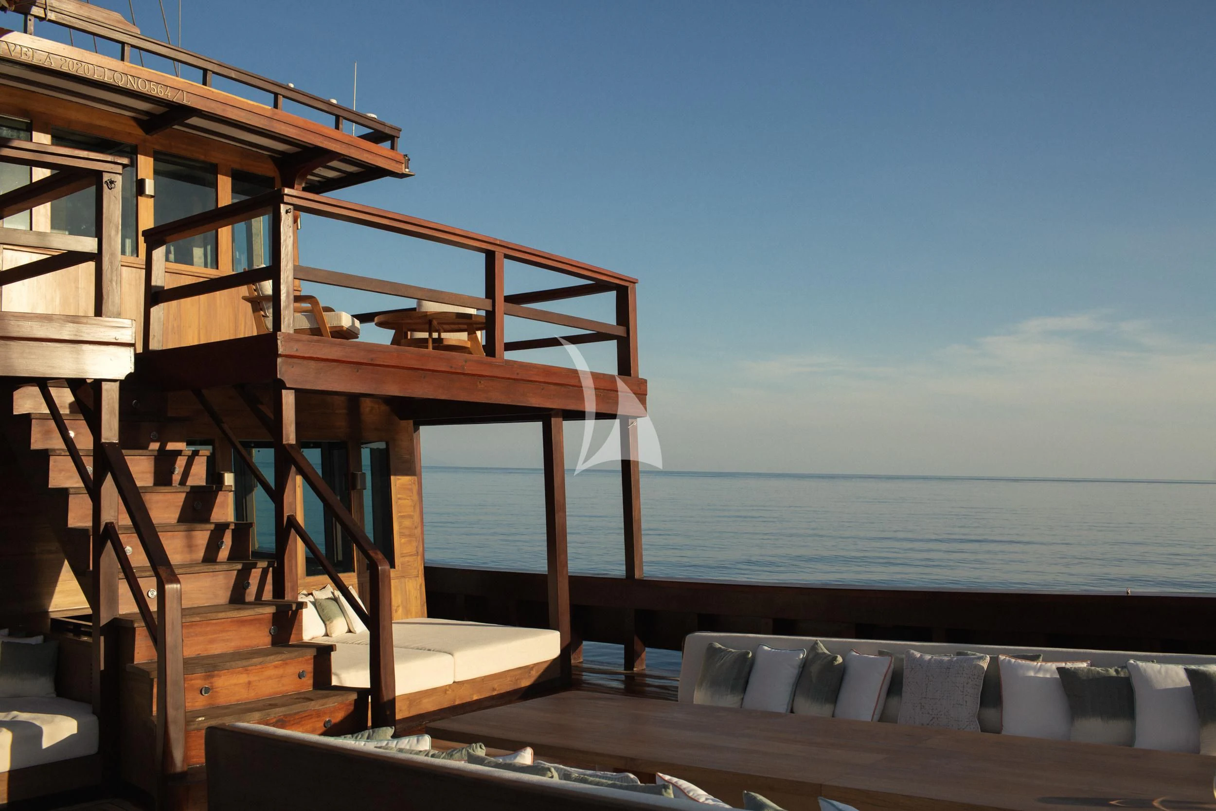a wooden house on a beach aboard VELA Yacht for Charter