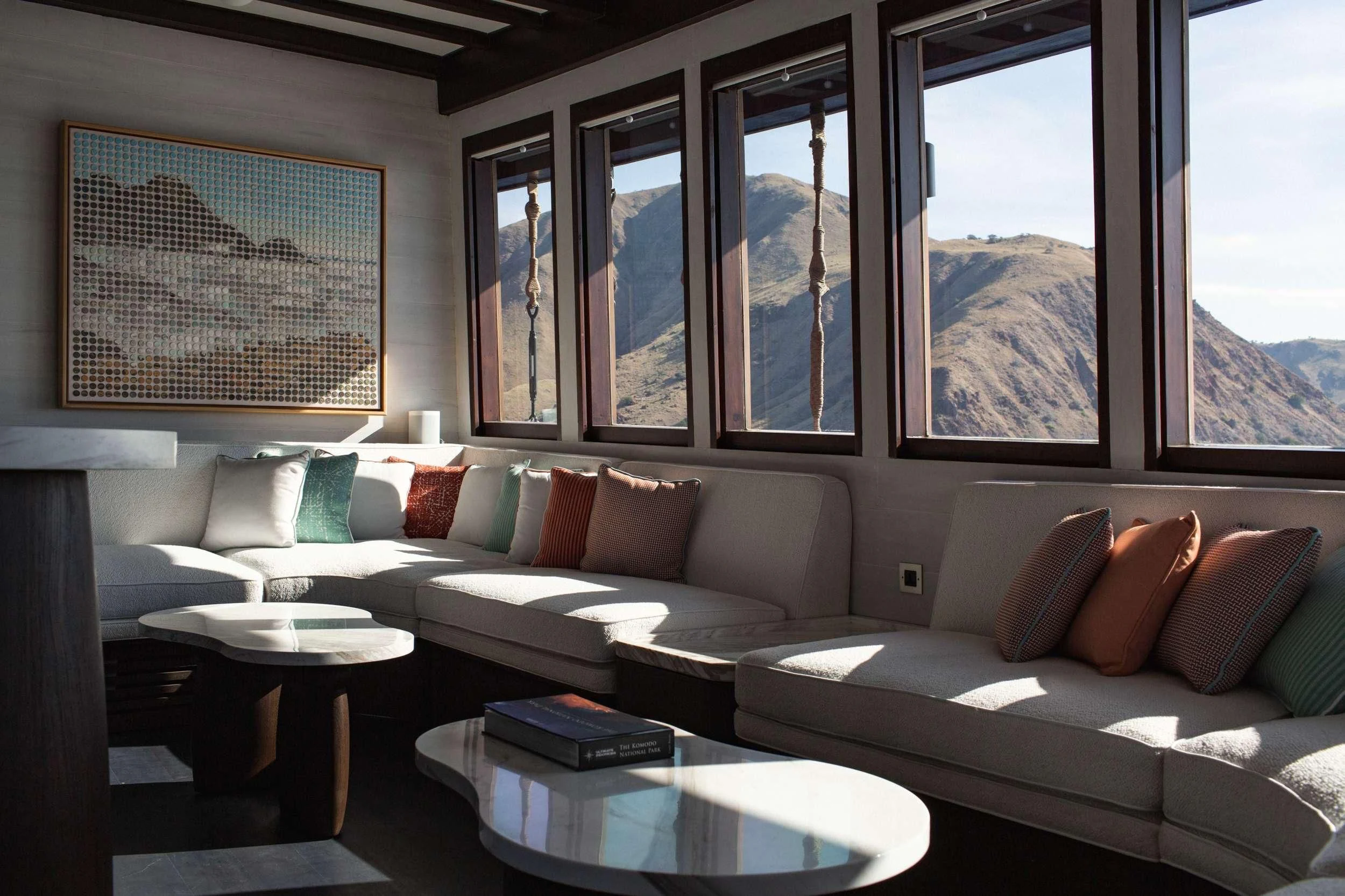 a living room with a couch and a table aboard VELA Yacht for Charter