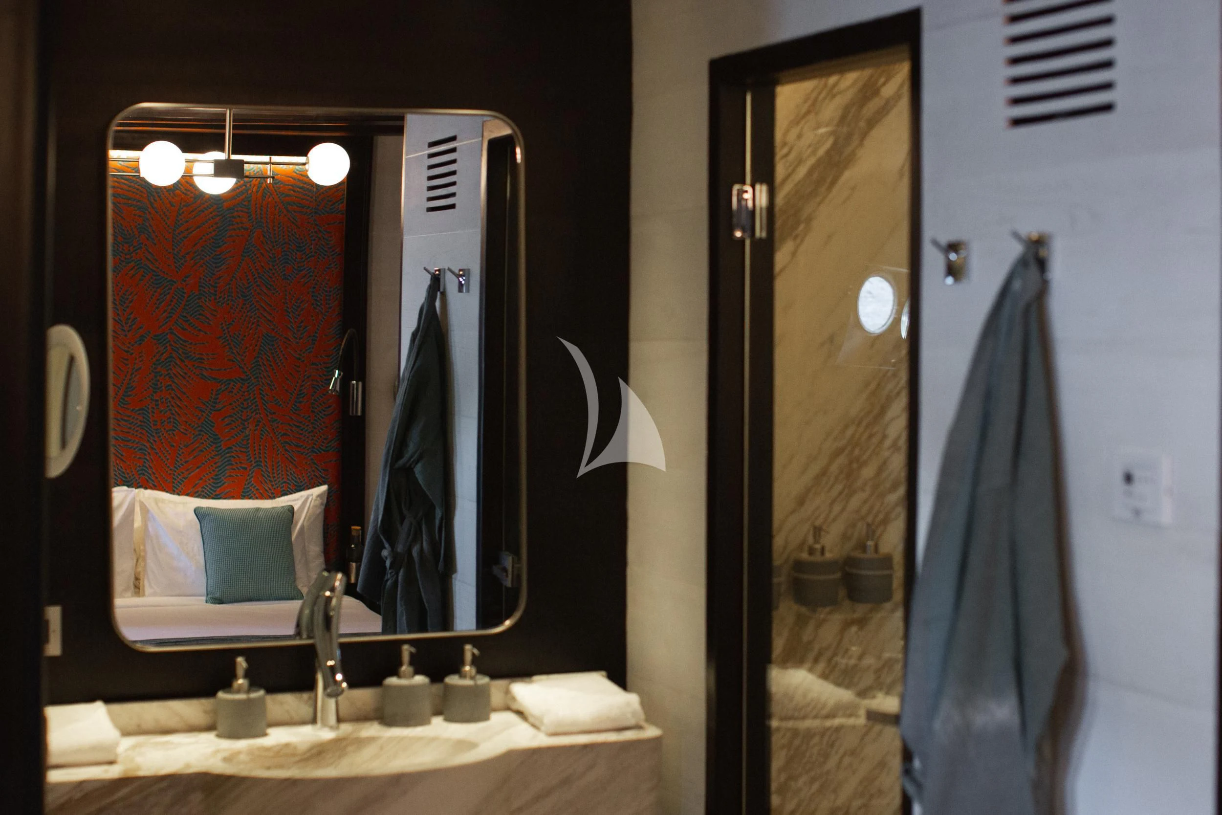 a bathroom with a large mirror aboard VELA Yacht for Charter