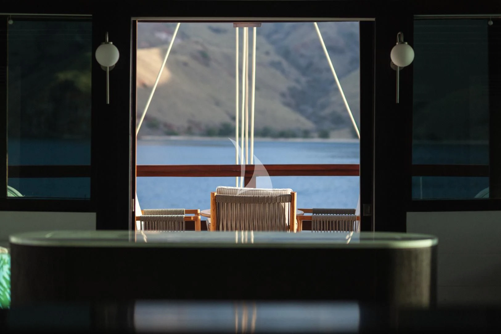 a room with a window and a view of the water aboard VELA Yacht for Charter