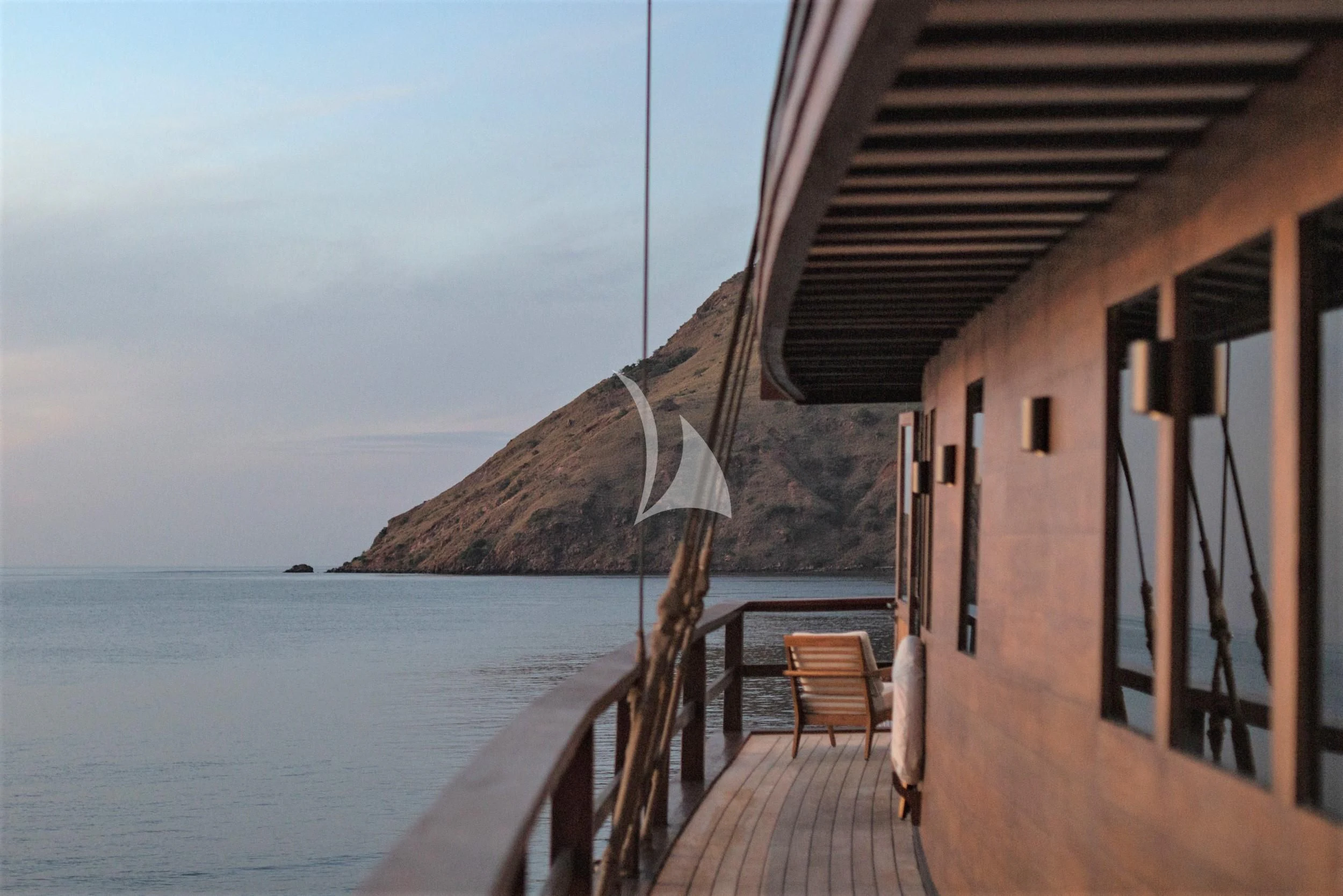 a building on a beach aboard VELA Yacht for Charter