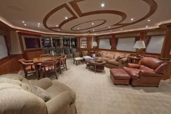 a living room with a large chandelier aboard LADY GRACE Yacht for Sale