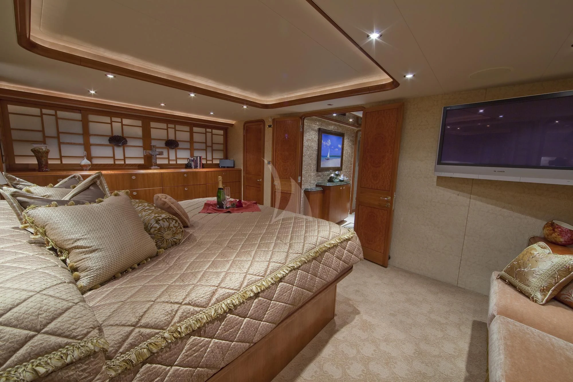 a bedroom with a bed and a tv on the wall aboard LADY GRACE Yacht for Sale