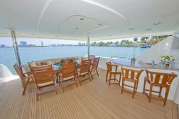 a room with a table and chairs aboard LADY GRACE Yacht for Sale