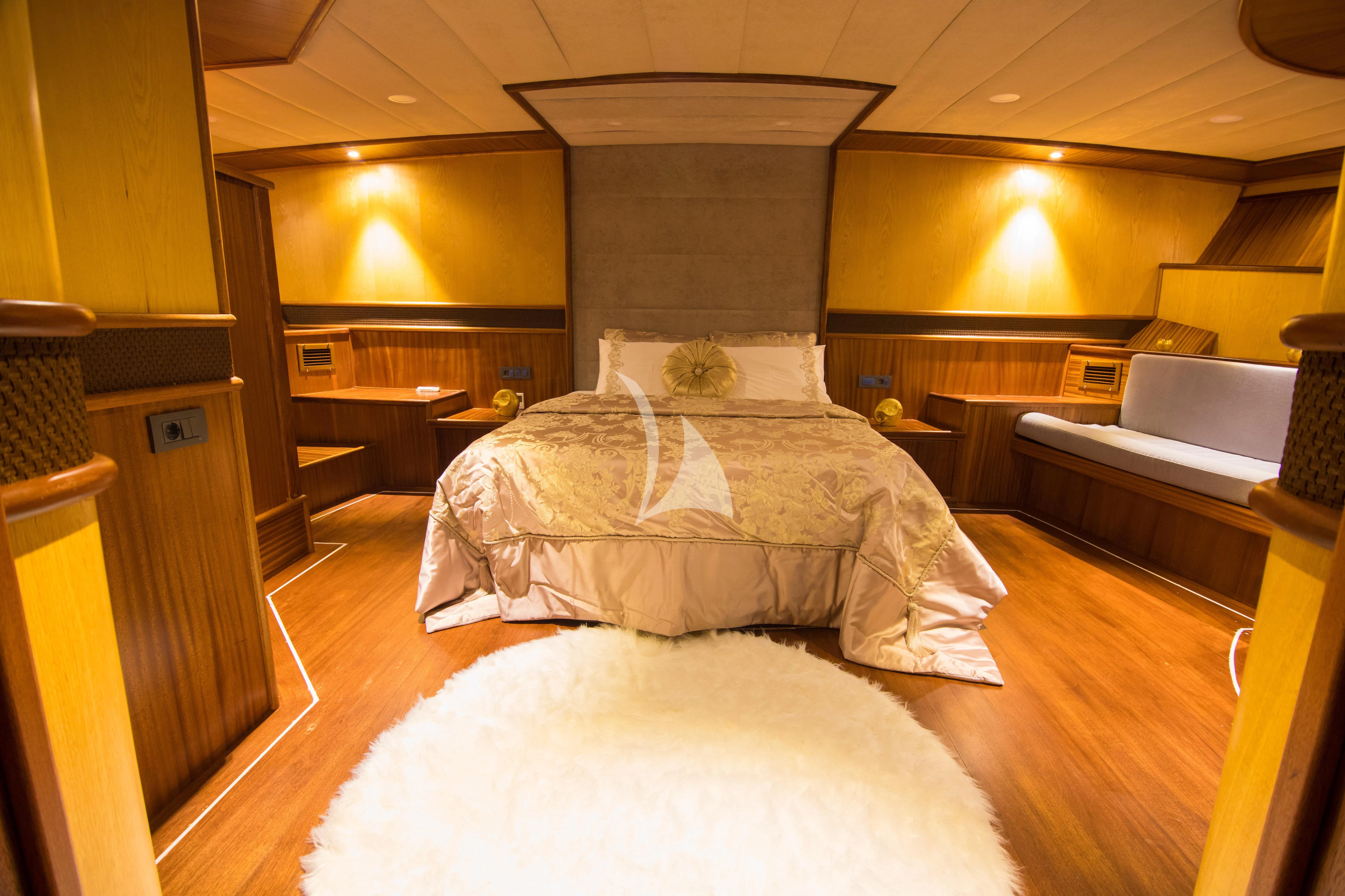 a room with a bed and a desk aboard NEVRA QUEEN Yacht for Sale