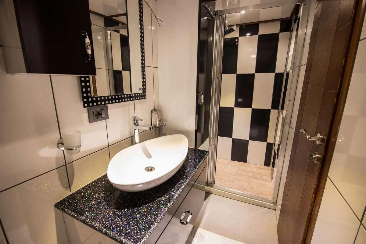 a bathroom with a sink and a mirror aboard NEVRA QUEEN Yacht for Sale
